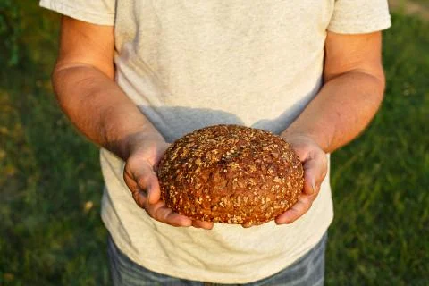 Bread in his hands Stock Photos