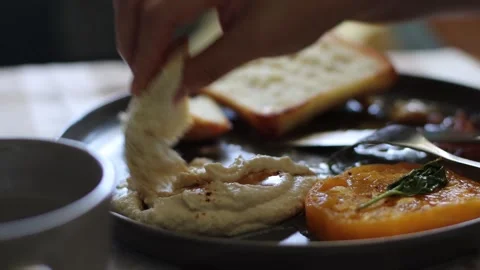 Bread hummus and tomatoes, 4k, real time, cinematic Stockbeeldmateriaal 248542373