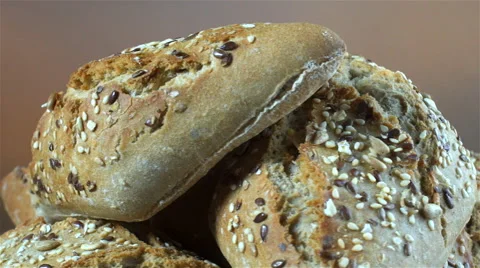 Bread isolated rotating on gray/brown background Stock Footage 62400571