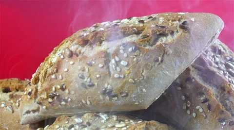 Bread isolated rotating on red/pink background with smoke Stock Footage 62402717