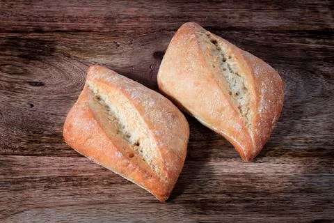 Bread isolated on wooden table Stock Photos
