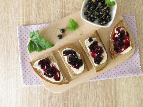 Bread with jam from black currants Stock Photos