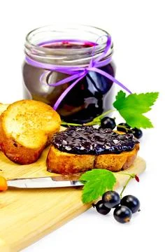 Bread with jam from blackcurrant on a board Slices of toasted bread, a gla... Stock Photos