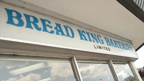 Bread king bakeries limited sign writing caption text storefront with windows Stock Footage 248250053