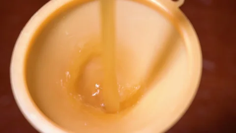 Bread kvass is poured through a watering can Stock Footage 253717835