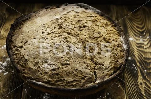Bread lies on a wooden surface Stock Photos