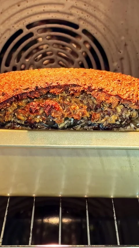 Bread Loaf Baking and Rising in Oven Viewed Through Door in Home Kitchen Stockbeeldmateriaal 337748047