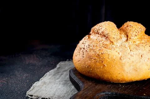 Bread loaf on black background Фото
