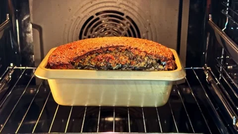 Bread Loaf Rising and Browning in Metal Pan Inside Home Kitchen Oven Stock Footage 337386474
