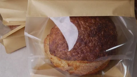 Bread Loaf in Transparent Plastic Bag. Stock Footage 313605649