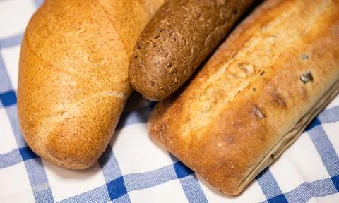 Bread loafs on tablecloth. Stock Photos