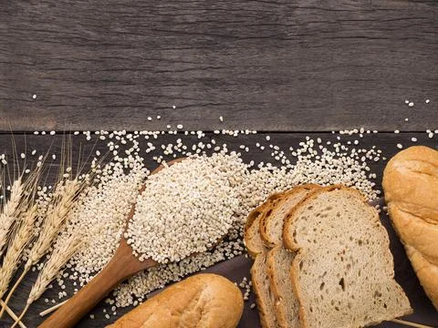 Bread loaves and sliced ??bread with wheat seeds put on a dark chalkboard On  Stock Photos