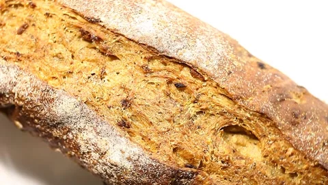 Bread, long loaf, dark, coarse ground, rotates, turning, top view Stock Footage 148147581