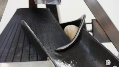 Bread making machine. Close up of round slice of dough falling down Stock Footage 131820586