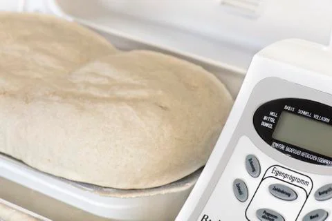 Bread making machine with rising dough Stock Photos