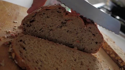 Bread - man cut slice with knife on a board with crumbs Stock Footage 46235245