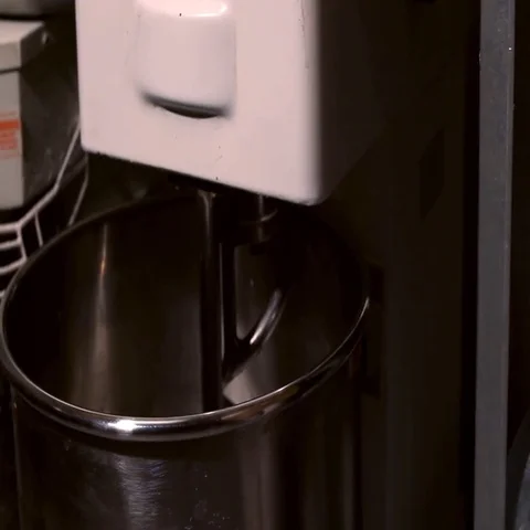 Bread Mixer In Bakery, mixing dough for baguettes in a bakery machine for mixing Stock Footage 69686175