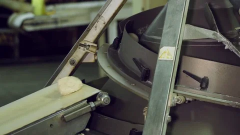 Bread moving on a conveyor belt, ready for baking in bakery Stock Footage 70749675