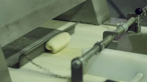 Bread moving on a conveyor belt, ready for baking in bakery Stock Footage 70749702