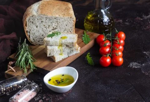 Bread, mozzarella, cherry tomatoes, olive oil, arugula and rosemary. Stock Photos