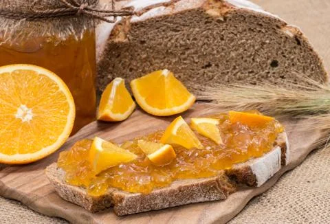 Bread with orange jam (rustic background) Stock Photos