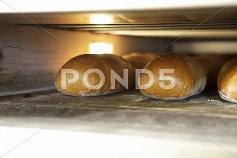 Bread in an oven Stock Photos