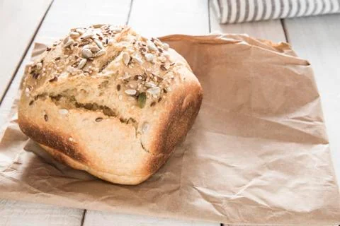 Bread over a white rustic wooden table. Stock Photos