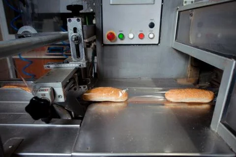 Bread packaging process on a conveyor belt Stock Photos