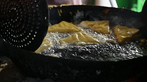 Bread pakora is being fried in hot oil. Stock Footage 296821898