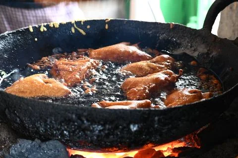 Bread pakora is being fried in hot oil. Stock Photos
