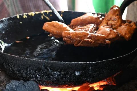 Bread pakora is being fried in hot oil. Stock Photos