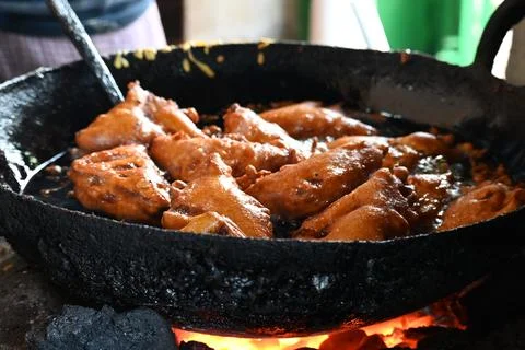 Bread pakora is being fried in hot oil. Stock Photos