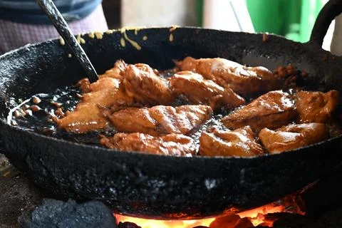 Bread pakora is being fried in hot oil. Stock Photos