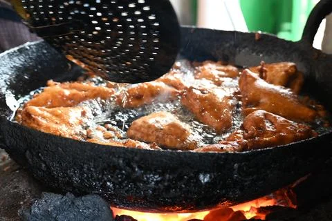 Bread pakora is being fried in hot oil. Stock Photos