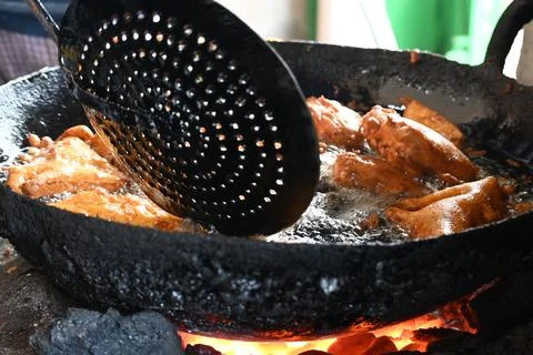 Bread pakora is being fried in hot oil. Stock Photos