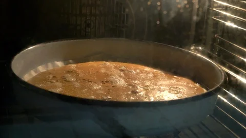 The bread pan is baked in the oven 스톡 동영상 128714795