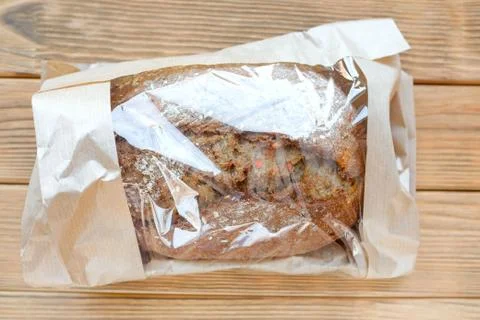 Bread in a paper bag. Transparent packaging. View from above Stock Photos