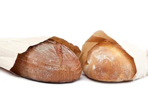 Bread in a paper bag on white background. Stock Photos