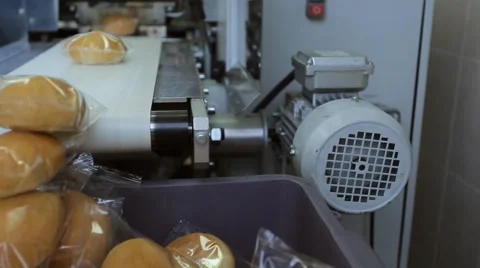 Bread for passengers of plane, packed on conveyor in transparent film Stock Footage 64986378