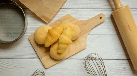 Bread placed on a white wooden table background Stock-Fotos