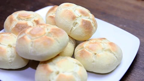 Bread on a plate on wood Stock Footage 94540785