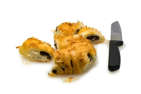 Bread pudding with coconut and knife on white background Stock Photos