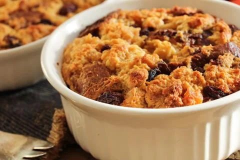 Bread pudding in a white ramekin close up view Fotos de archivo