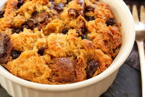 Bread pudding in a white ramekin close up view Fotos de archivo