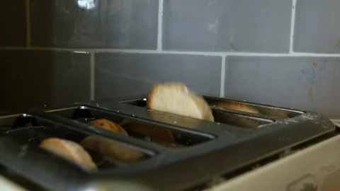 Bread is put into a toaster 動画素材 98659537