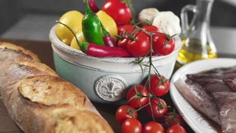Bread with raw calamari and fresh vegetables on the kitchen table Stock Footage 143590613