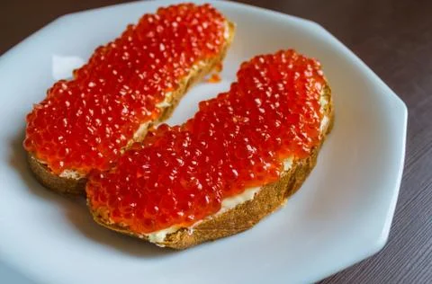 Bread with red caviar. Stock Photos