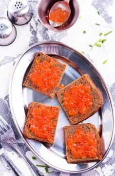 Bread with red salmon caviar Stock Photos