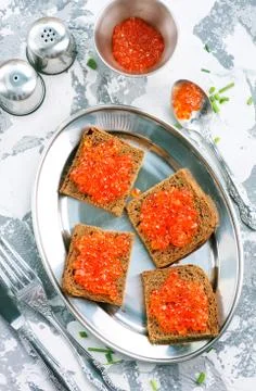 Bread with red salmon caviar Stock Photos