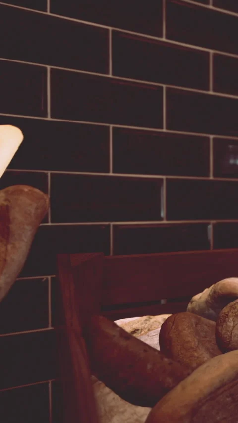 Bread is resting on a wooden table in a bakery kitchen in the morning Stock Footage 340644409